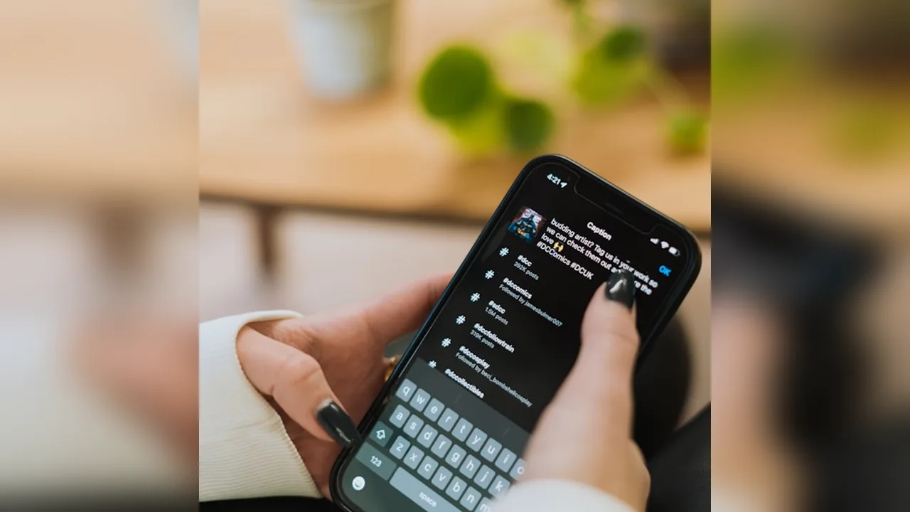 A phone keyboard with hashtag typing on a social post